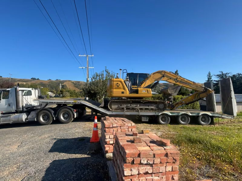 Excavator loaded on a transporter for machinery transport