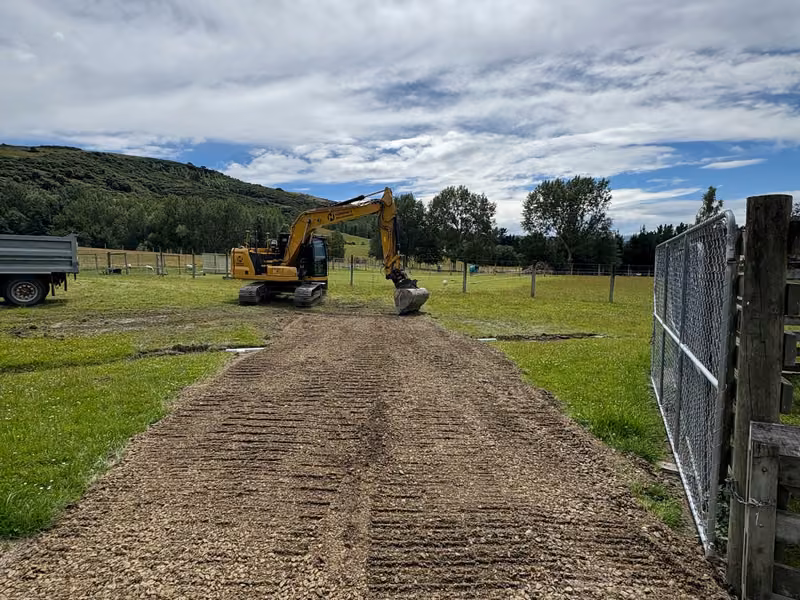 Formed rural access track with earthmoving equipment on site